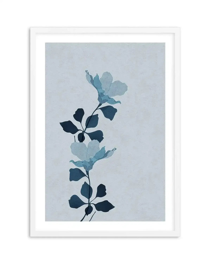 Art print featuring two stylized botanical illustrations of flowers with leaves on a light blue-grey background, printed on fine art paper and displayed in a white frame with white border. The flowers are depicted in translucent shades of light blue and teal, while the leaves are a solid deep navy blue. The background has a subtle, textured appearance.