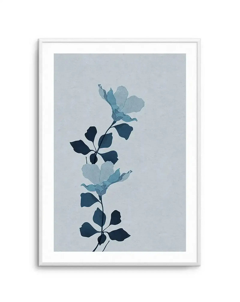 Watercolour art print featuring two delicate, translucent blue flowers with dark blue leaves on a light blue-grey background, displayed in a white frame with a white border.