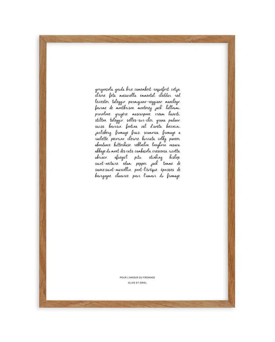 Framed art print with natural wood frame displaying handwritten script text listing international cheese varieties including gorgonzola, gouda, brie, camembert, and many others in flowing cursive handwriting on white background. Text is centered on the page with "POUR L'AMOUR DU FROMAGE" and "OLIVE ET ORIEL" printed in small black capital letters at the bottom of the frame.