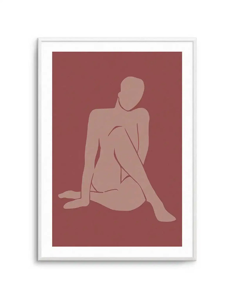 Minimalist art print featuring a seated female figure in a light terracotta hue against a deep rouge background, printed on fine art paper and displayed in a white frame with white border. The figure is rendered in a flat, graphic style with clean lines and no facial features, with one leg bent and the other extended.