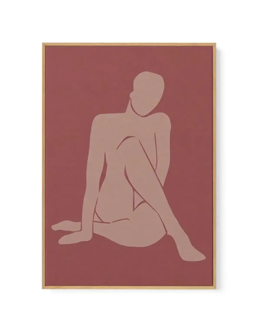 Framed canvas art print titled Forme Feminine I featuring a minimalist line drawing of a seated nude female figure in soft beige tones against a deep mauve-red background. The figure is shown in profile, sitting with legs extended, rendered in simple curved lines. Natural wood-toned frame with subtle shadow effect visible on white background.