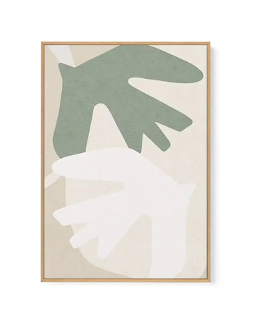 Abstract canvas print featuring two large, organic shapes resembling stylized leaves or hands, one in muted sage green and the other in soft cream, overlapping on a pale beige background, displayed in a natural oak frame.