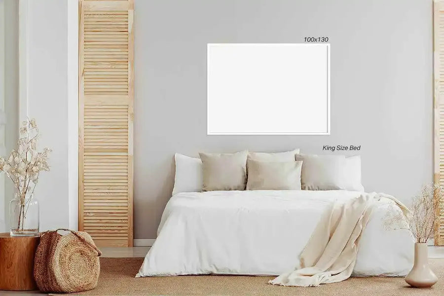 Horizontal art print with white border and light gray frame displayed above a king size bed with cream and beige pillows and bedding. The bedroom features natural wood louvered doors on either side, a beige area rug, and neutral botanical decor including dried grasses in vases and woven baskets with rust and cream-toned textiles on the left side. The print dimensions are marked as 100x130 centimeters.