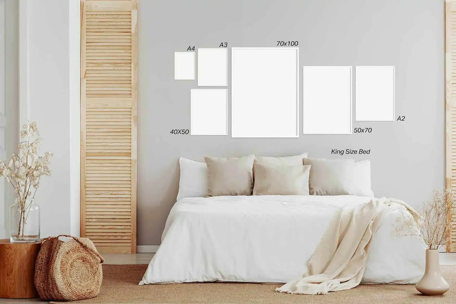 Bedroom wall mockup displaying six art prints in various sizes arranged above a king-size bed with white bedding. Frame sizes shown include A4, A3, 70x100 centimeters, 40x50 centimeters, 50x70 centimeters, and A2, all with white borders. The serene bedroom features natural wood louvered shutters on either side, dried pampas grass in ceramic vessels, a woven basket, and cream-toned bedding and throw blanket, creating a minimalist, neutral aesthetic.