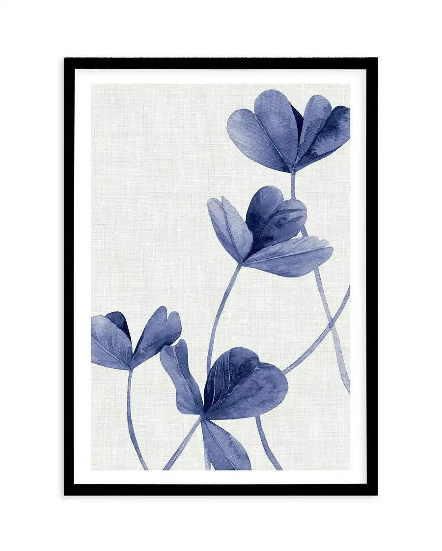 Watercolour art print featuring five stylized clover-like leaves in varying shades of indigo and periwinkle blue, with delicate stems extending upwards on a textured cream background, displayed in a black frame with white border.