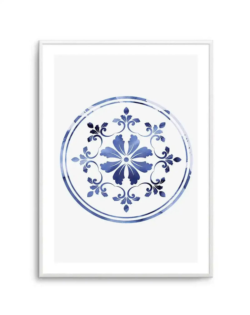 Watercolour art print featuring a circular medallion design with a central floral motif and surrounding ornate scrollwork in varying shades of indigo and cerulean blue on a crisp white background, displayed in a white frame with white border.