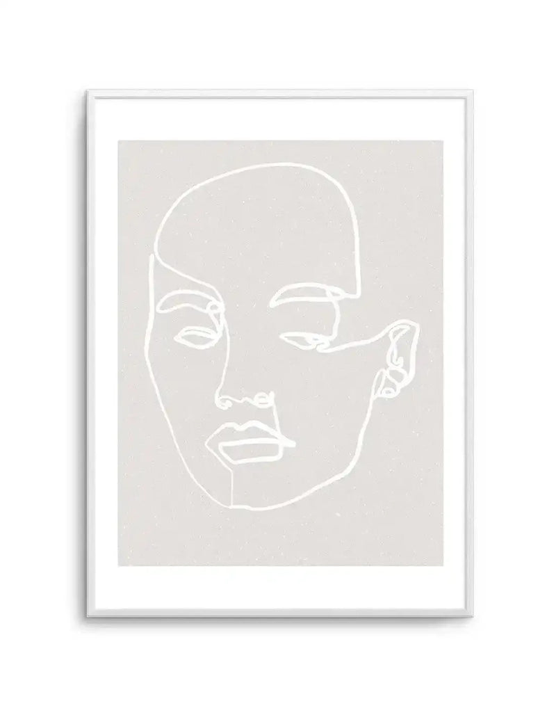 Line art print featuring a minimalist illustration of a woman's face in white on a light grey background with a subtle speckled texture, displayed in a white frame with white border. The continuous line drawing outlines the contours of her face, with closed eyes, nose, and lips.