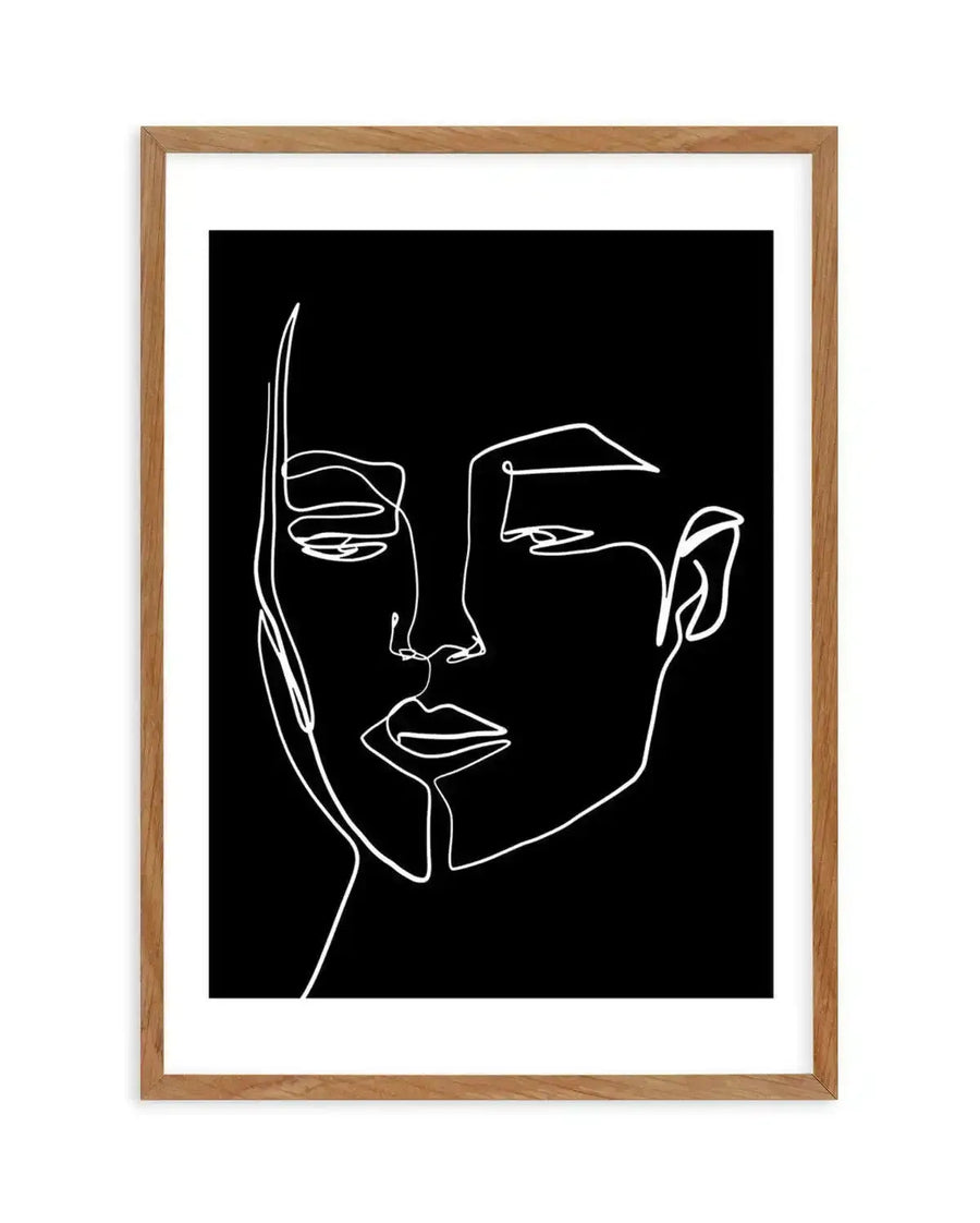 Art print featuring a minimalist continuous line drawing of a woman's face in white on a black background, displayed in a natural oak frame with white border. The artwork depicts the woman's profile with subtle curves and lines forming her eyes, nose, and lips, conveying a serene and contemplative mood.