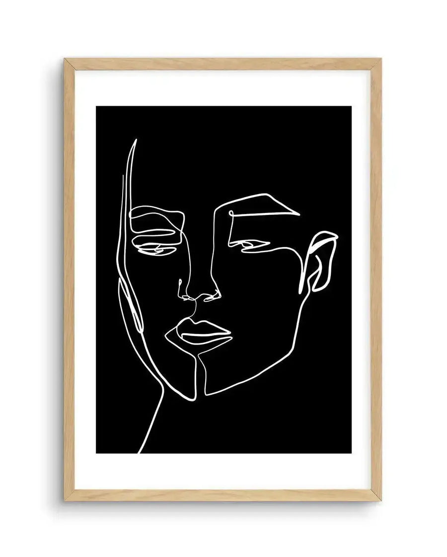 Art print featuring a minimalist one-line drawing of a woman's face in white on a black background, displayed in a natural oak frame with white border. The continuous line forms the contours of her face, including her eyes, nose, and lips, with a subtle, contemplative expression.