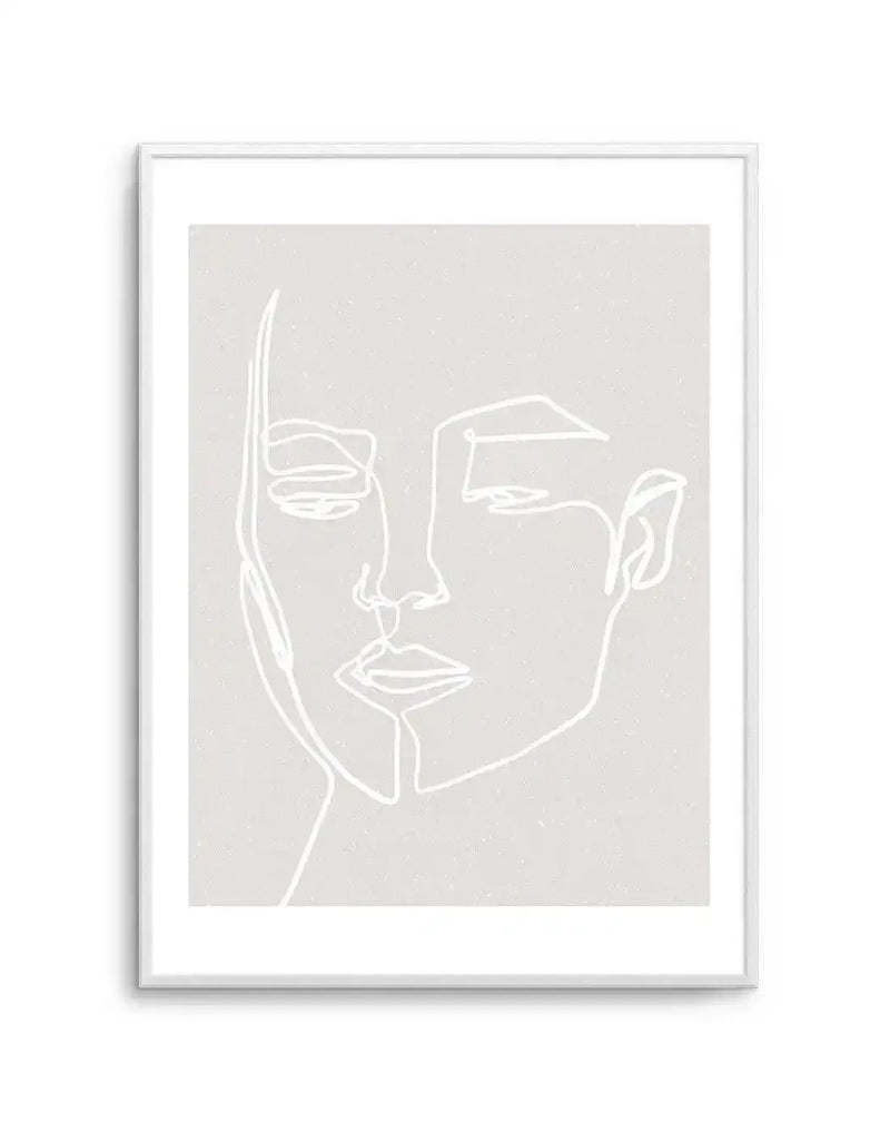 Line art print featuring a minimalist illustration of a woman's face in white on a light grey, subtly textured background, displayed in a white frame with a white border. The continuous line drawing depicts the contours of her face, with closed eyes, nose, and lips.