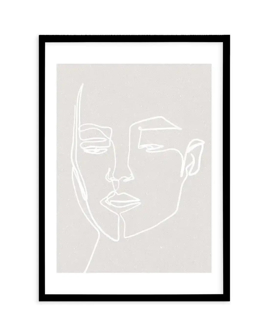Line art print featuring a minimalist illustration of a woman's face in white on a textured light grey background, displayed in a black frame with white border. The single continuous line drawing outlines the profile of her face, with closed eyes, nose, and lips.