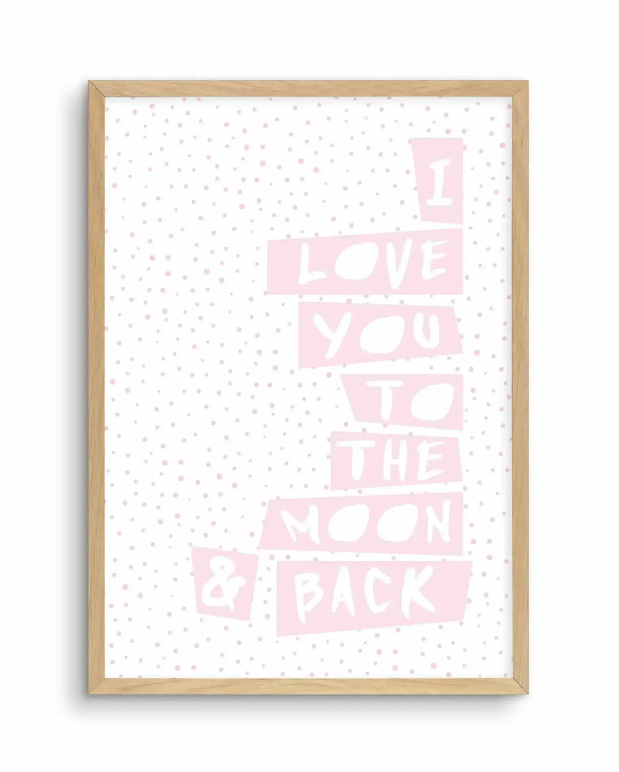 Art print featuring the phrase "I LOVE YOU TO THE MOON & BACK" in a playful, hand-drawn style with white letters on light pink rectangular blocks, set against a white background with scattered small pink polka dots, displayed in a natural oak frame with white border.