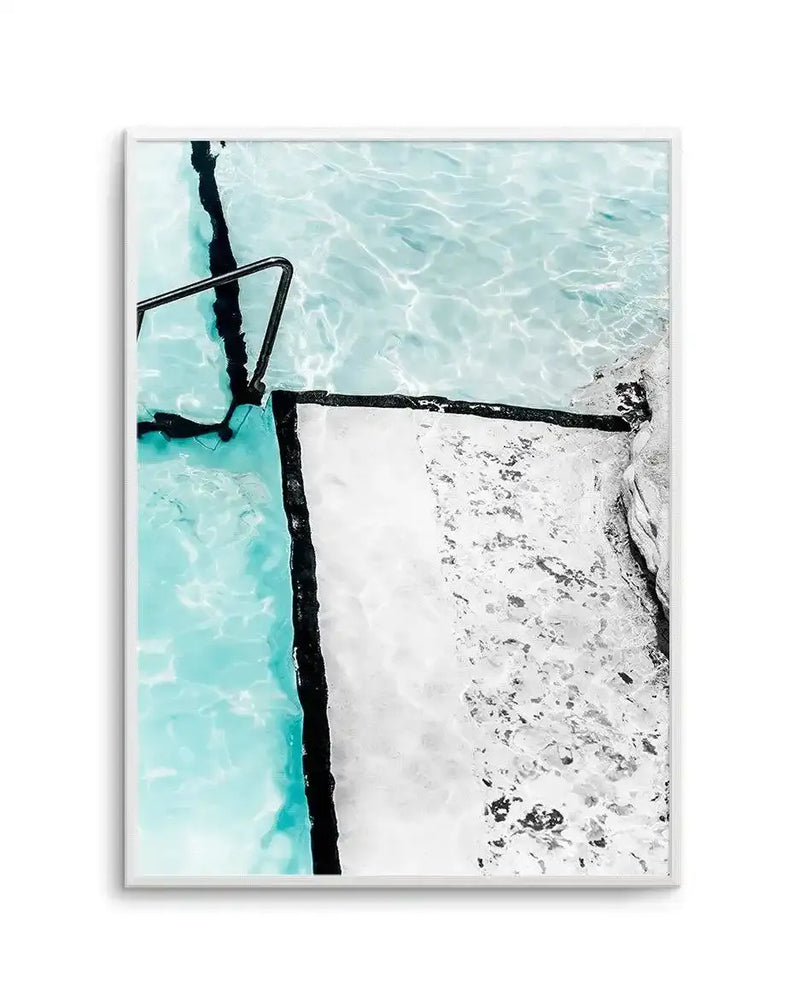Framed photography art print of a swimming pool with a black lane line and a metal handrail, with the water in a bright turquoise blue and the surrounding concrete in a textured white and grey.
