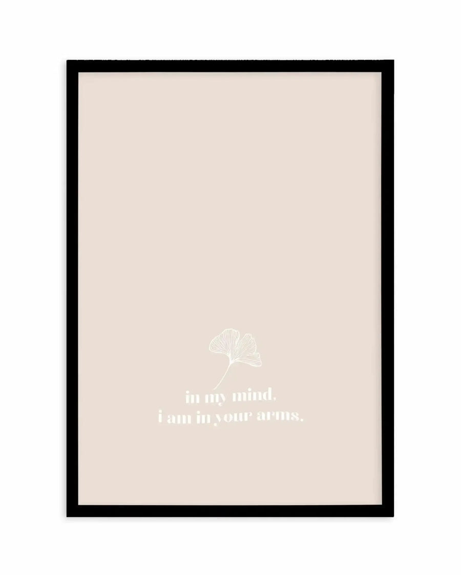 Framed art print with black frame containing cream-colored background. A delicate white line drawing of a ginkgo leaf appears in the upper-center portion. Below it, white sans-serif text reads "in my mind. i am in your arms." The minimalist design has a contemplative, romantic mood with soft neutral tones throughout.