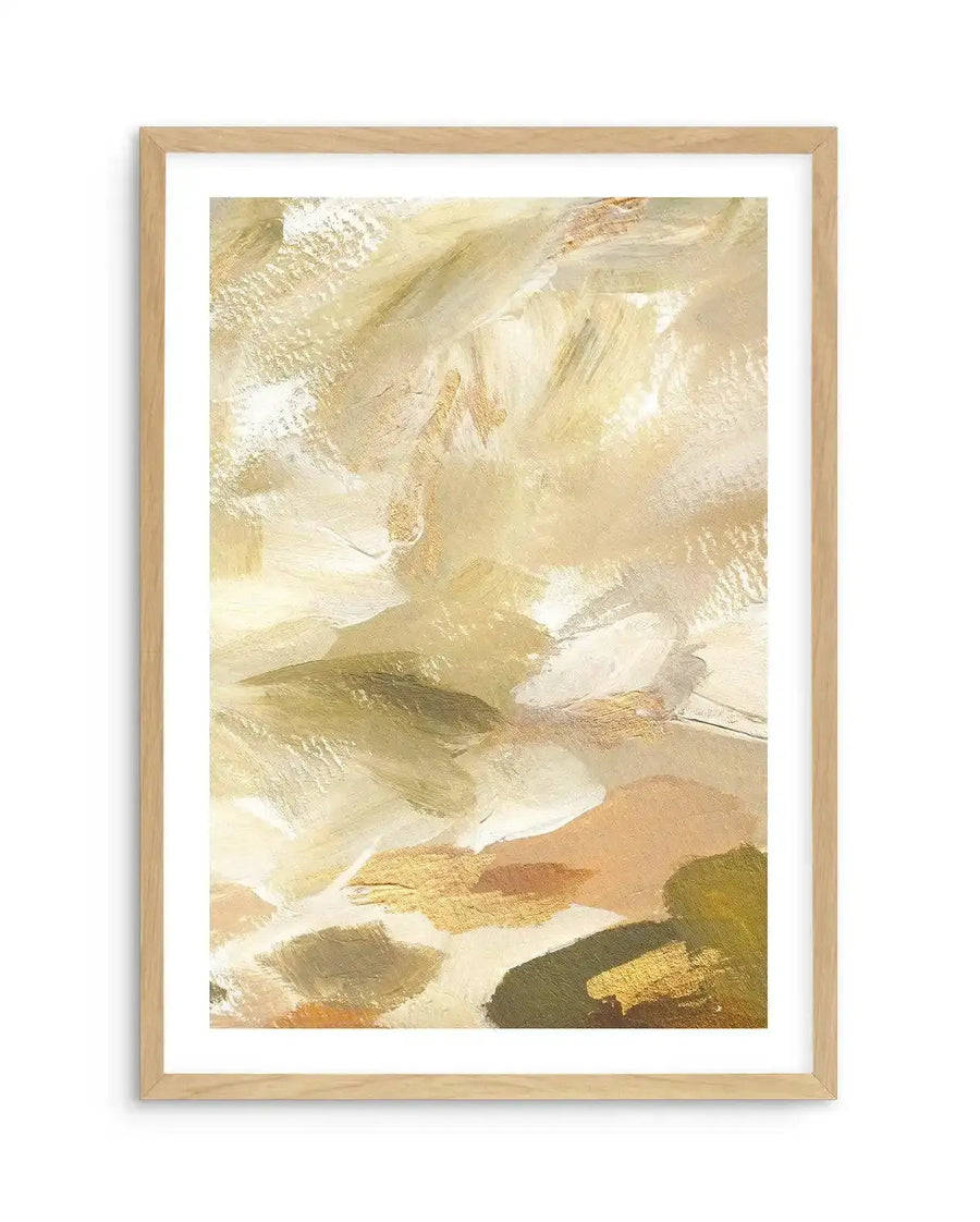 Khaki Luxe I Art Print displayed in a natural wood frame with white border. Abstract painting featuring layered brushstrokes in warm earth tones including cream, khaki, sage green, tan, and soft gold. The composition shows gestural paint marks creating an organic, flowing composition with areas of transparency and opacity. The overall effect is calming and contemplative, with a soft, matte finish suggesting acrylic or gouache painting technique.