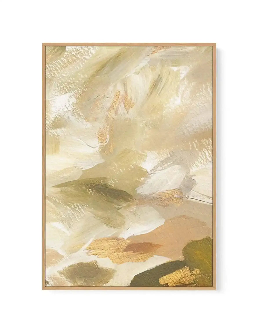 Framed canvas art print featuring an abstract composition in warm, neutral tones. The design showcases layered brushstrokes in cream, ivory, khaki, sage green, and gold leaf accents, creating a textured, painterly effect. Soft sweeping marks and organic shapes blend across the canvas in a contemporary style. The artwork is displayed in a natural wood frame with a white border, presented against a plain background.