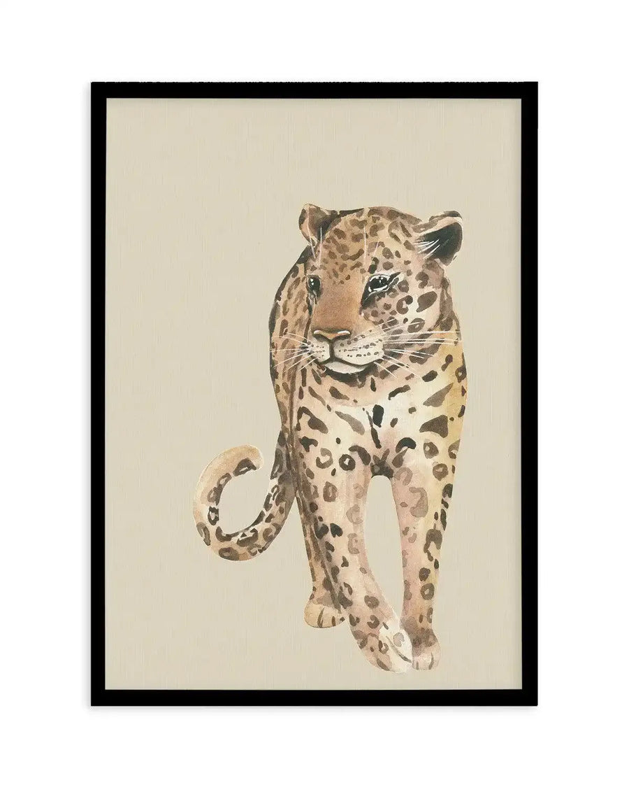 Watercolour art print featuring a leopard walking towards the viewer, with a light brown and cream spotted coat, on a plain cream background, printed on fine art paper and displayed in a black frame with white border.