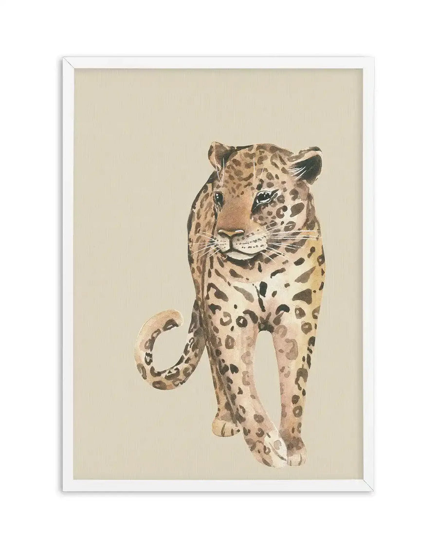 Watercolour art print featuring a leopard walking forward on a warm beige background, printed on fine art paper and displayed in a white frame with white border. The leopard has light brown fur with dark brown spots and a light-colored belly, with its tail curled behind it.