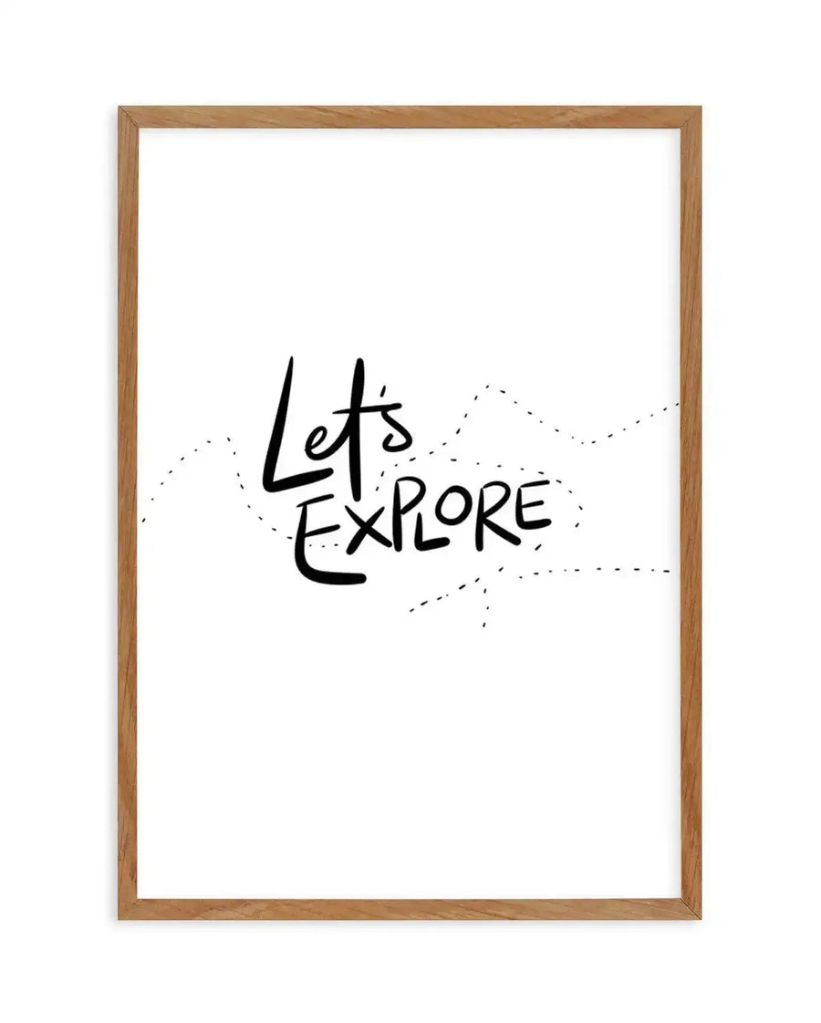 Art print in natural wood frame featuring hand-lettered text reading "Let's Explore" in black ink on white background, with decorative dotted line design suggesting a winding path around the text, creating a minimalist and adventurous aesthetic.