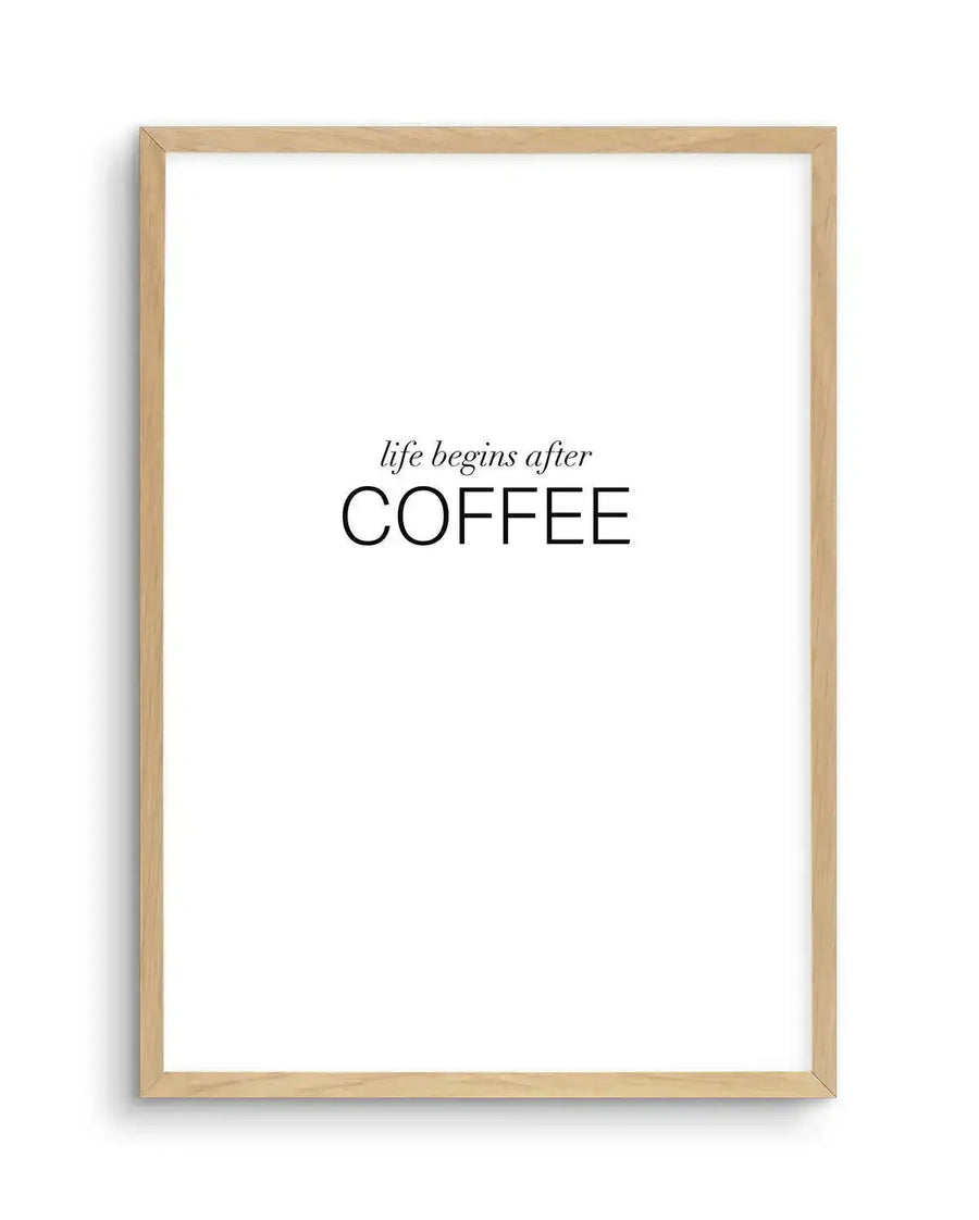 Art print featuring the phrase "life begins after COFFEE" in black serif font, with "life begins after" in smaller, italicized letters and "COFFEE" in larger, uppercase letters, displayed in a natural oak frame with white border.