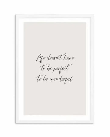 Art print featuring the handwritten quote "Life doesn't have to be perfect to be wonderful" in black script on a light grey background, displayed in a white frame with a white border.