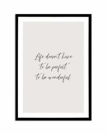 Art print featuring the quote "Life doesn't have to be perfect to be wonderful" in elegant black script on a light grey background, displayed in a black frame with a white border.