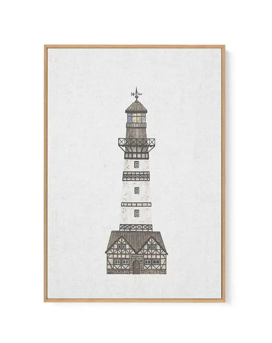 Framed canvas art print featuring an illustration of a lighthouse with a house at its base, on a textured white background, with a natural wood frame. The lighthouse is white with dark grey accents and windows, and a weather vane on top pointing N-W. The house at the base has a dark grey roof and timber-framed walls with white infill.