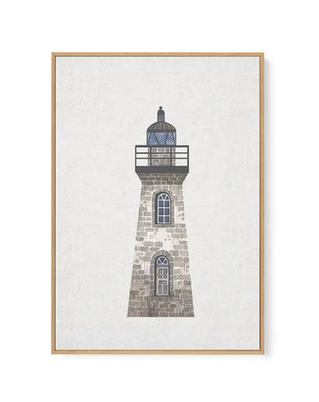 Framed canvas art print of a tall lighthouse with a stone brick base rendered in muted gray and tan tones. The lighthouse features two arched windows with fan-shaped tops and a cylindrical lantern room at the top with a dark dome and railing. The artwork is displayed in a natural wood frame with a cream-colored linen canvas background, creating a coastal, minimalist aesthetic with a textured, illustration-style finish.