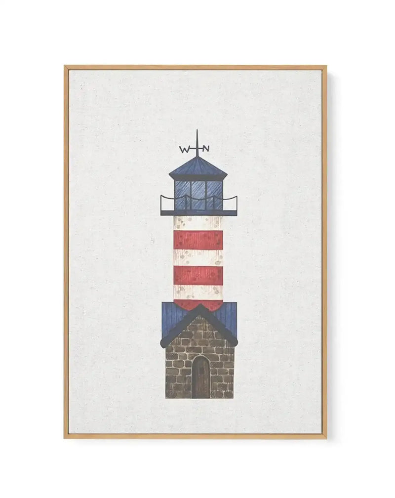 Framed canvas art print featuring a stylized lighthouse with a red and white striped tower, a blue roof, and a stone base with an arched wooden door. A weather vane with "W" and "N" is on top of the blue roof. The artwork has a textured, slightly distressed appearance on a cream background, displayed in a natural wood frame.
