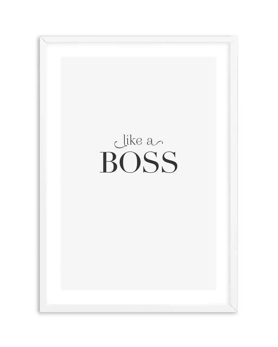 Art print featuring the words "like a" in a delicate script font above the word "BOSS" in a bold, serif uppercase font, all in black on a clean white background, displayed in a simple white frame with white border.
