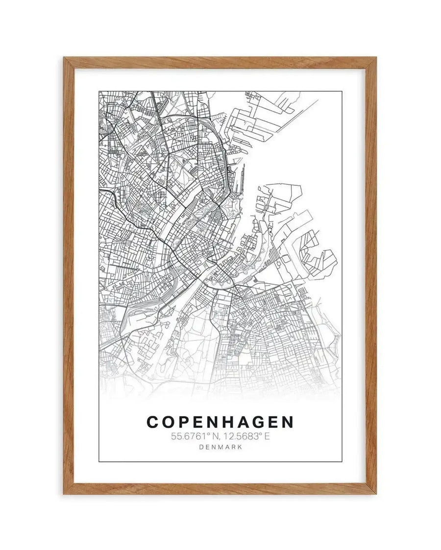 Line art map print of Copenhagen, Denmark, featuring a detailed street network in black lines on a white background, with a subtle grey gradient at the bottom. The print is displayed in a natural oak frame with a white border. Below the map, the text "COPENHAGEN", "55.6761° N, 12.5683° E", and "DENMARK" is printed in black.