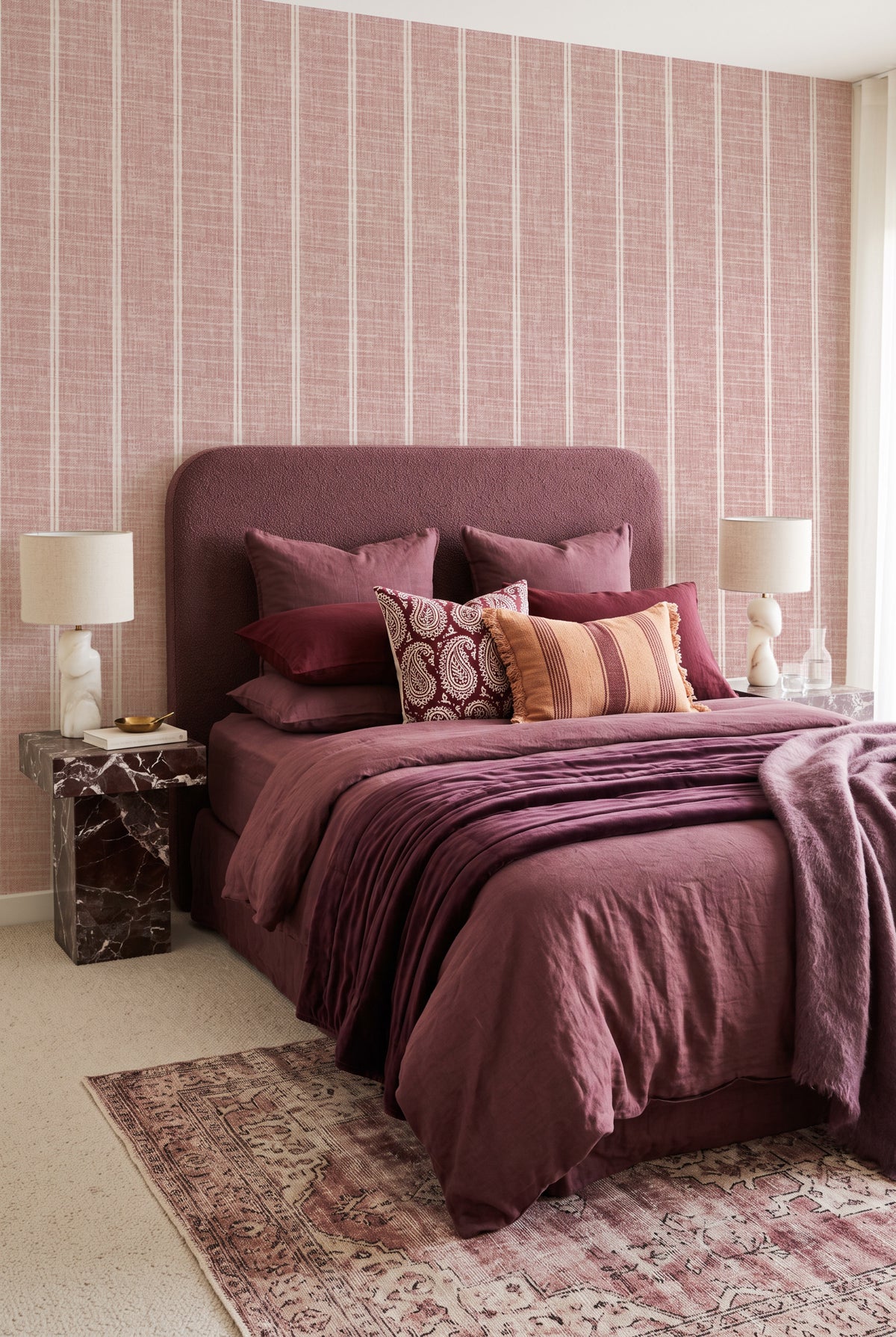 Dusty Rose Pink Linen Double Stripe linen wallpaper styled in a warm bedroom