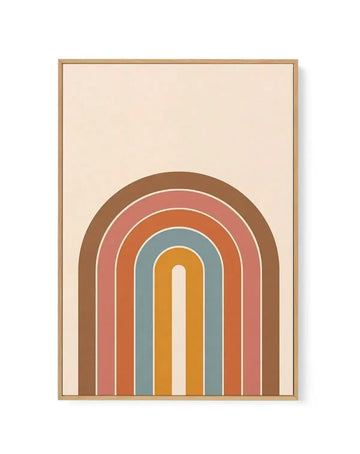 Framed canvas art print featuring a centered geometric rainbow design with concentric arched stripes in warm and cool tones: outermost brown, dusty rose, burnt orange, muted teal, and golden yellow, with a cream-colored center, all set against a pale beige background. Natural wood frame with thin white border.