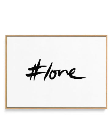Black brush-script #love framed canvas in oak frame, product shot on white background
