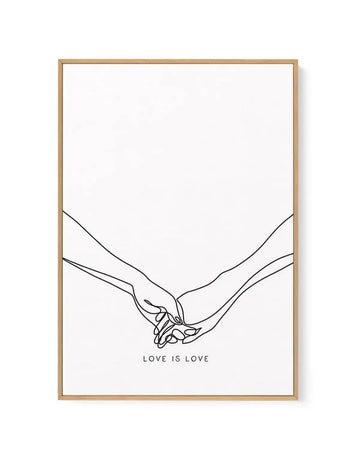 Framed canvas art print featuring a minimalist line drawing of two hands holding each other against a white background. The hands are rendered in simple black ink lines showing interlocked fingers in a tender gesture. Below the illustration, the text "LOVE IS LOVE" appears in small, centered capital letters. The canvas is mounted in a natural wood frame with a warm tan finish.
