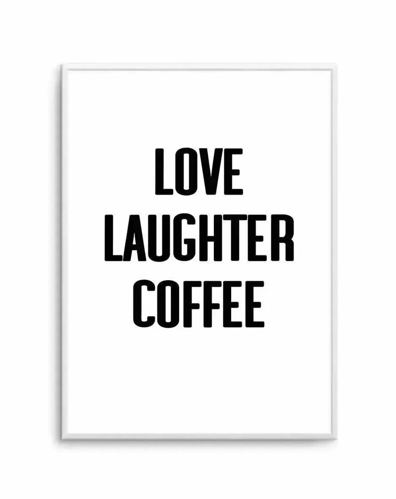 Framed art print with black bold sans-serif typography on a white background. The text reads "LOVE LAUGHTER COFFEE" in three centered lines. The print is mounted in a light gray or silver frame with a white border. The design has a clean, minimalist aesthetic with high contrast between the black lettering and white background.