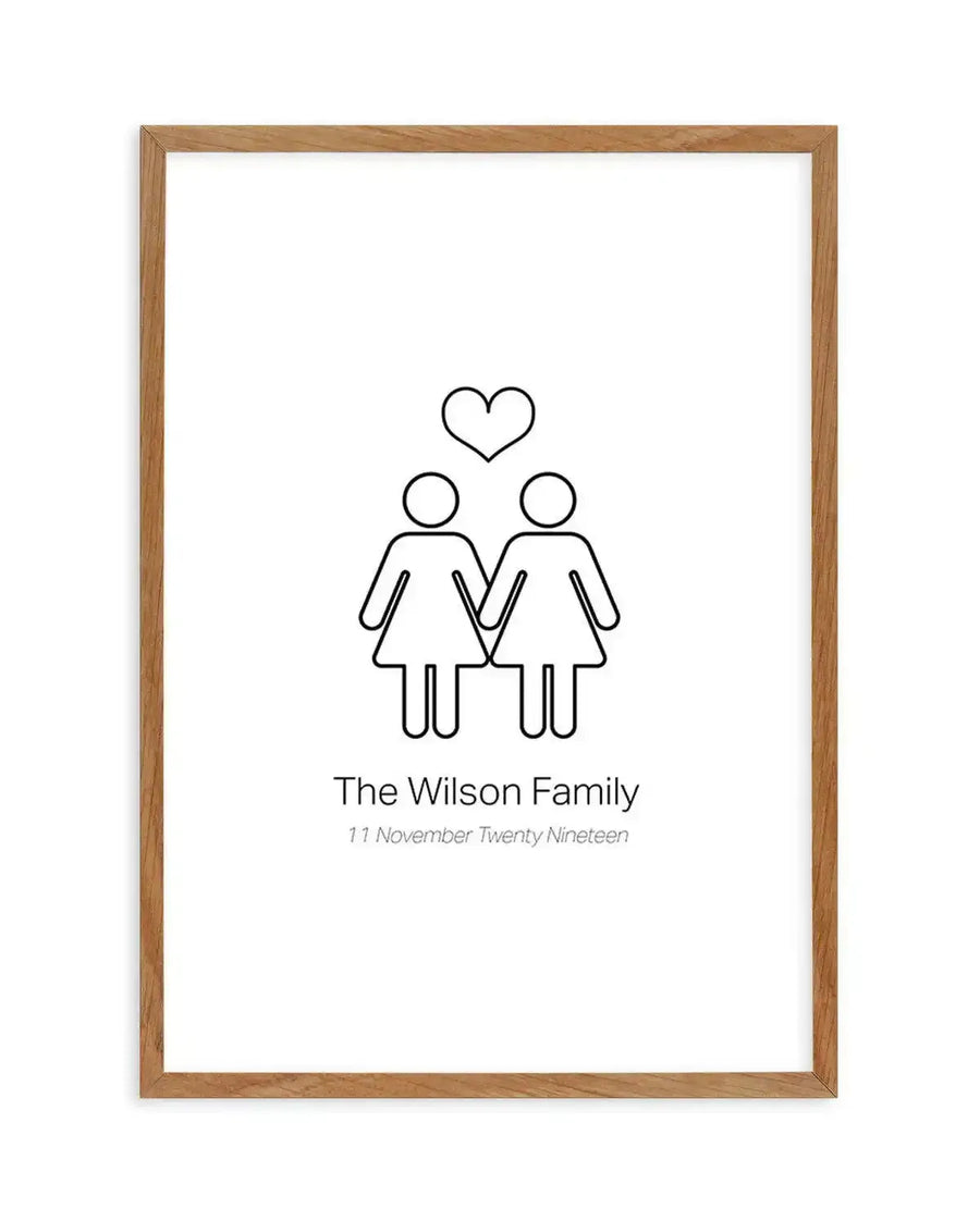 Art print featuring a minimalist black outline illustration of two female figures holding hands with a heart shape above their heads, on a white background. The text below reads "The Wilson Family" and "11 November Twenty Nineteen". The print is displayed in a natural oak frame with a white border.