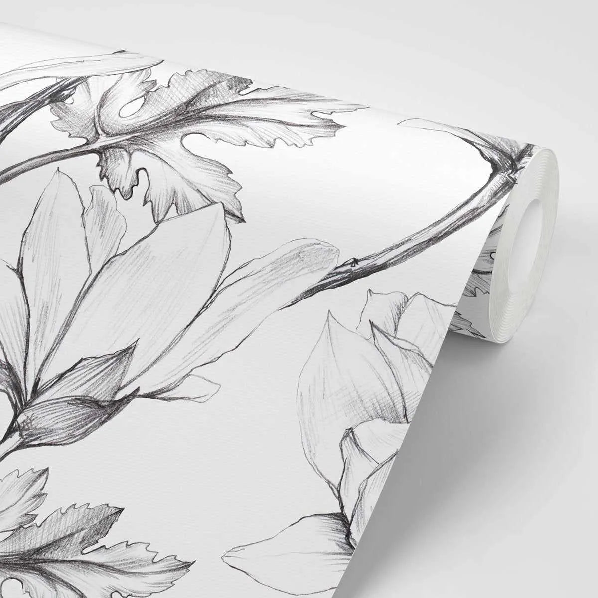 Peel and stick wallpaper featuring a repeating pattern of hand-drawn magnolia flowers and leaves in black and white pencil sketch style. The botanical design has visible pencil strokes and shading, creating a detailed and organic illustration on a white background. The wallpaper is shown rolled up, revealing the pattern on the surface.