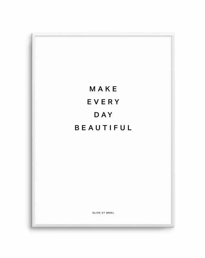 Framed art print with white border featuring centered black text reading "MAKE EVERY DAY BEAUTIFUL" in sans-serif capital letters on a white background. Silver-gray frame with minimal depth. Small text credit at bottom reads "OLIVE ET ORIEL". Minimalist, typographic design with clean composition and ample white space.