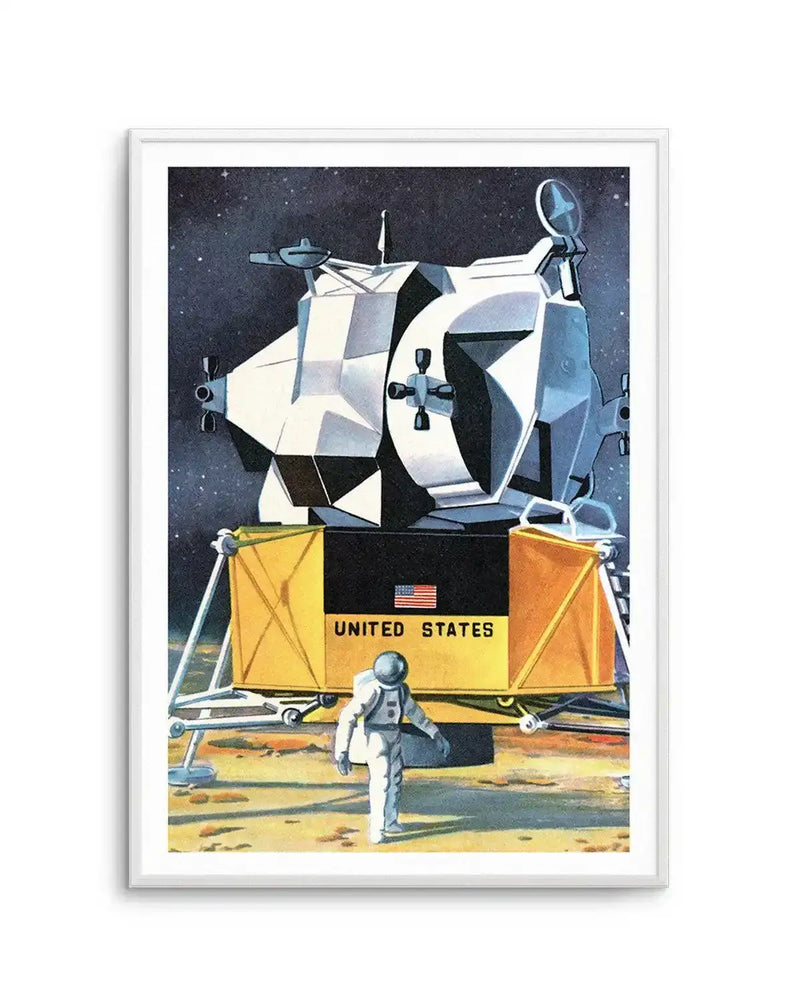 Retro-style art print depicting an astronaut on the moon next to a lunar lander, with a dark starry sky in the background. The lander is predominantly white and grey with gold accents, featuring "UNITED STATES" and an American flag on its base. The astronaut, in a white suit, stands on the dusty, ochre-coloured lunar surface. The print is displayed in a white frame.