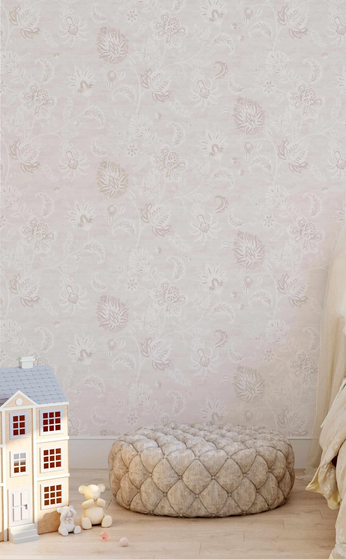 Children's Bedroom:
"Marsielle in Vanilla wallpaper featuring a repeating pattern of large-scale floral and paisley motifs in muted vanilla, soft beige, and pale pink on a light cream background, creating a delicate, traditional design. The wallpaper is displayed on a wall in a child's bedroom, with a light wooden dollhouse, two teddy bears, and a tufted beige ottoman on a light wood floor."
