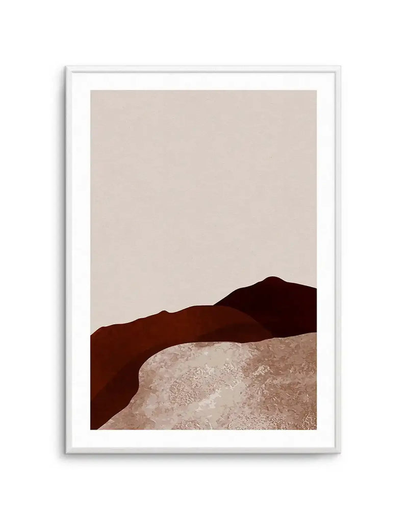 Abstract art print featuring a minimalist desert landscape with rolling hills and a textured foreground. The composition includes deep reddish-brown and dark brown hills against a pale beige sky, with the foreground showing a lighter, textured sandy or rocky terrain in shades of light brown and beige. The print is displayed in a white frame with a white border.