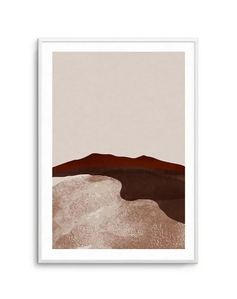 Abstract art print featuring layered, undulating shapes in warm, earthy tones. The composition includes a dark reddish-brown mountain range against a pale beige sky, with a lighter brown, textured foreground suggestive of sand dunes or a desert landscape. Printed on fine art paper and displayed in a white frame with white border.