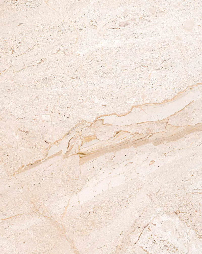 Blush marble wallpaper featuring a soft, neutral palette of cream, pale pink, and warm beige tones. The design displays organic veining and flowing streaks reminiscent of natural stone, with delicate linear patterns and subtle color variations throughout. The textured surface mimics polished marble with a matte finish, creating depth through layered tones and fine speckled details across the entire surface.