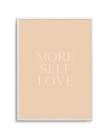 Art print featuring the words "MORE SELF LOVE" in a light cream serif font on a warm, pale peach background, displayed in a white frame with a white border.