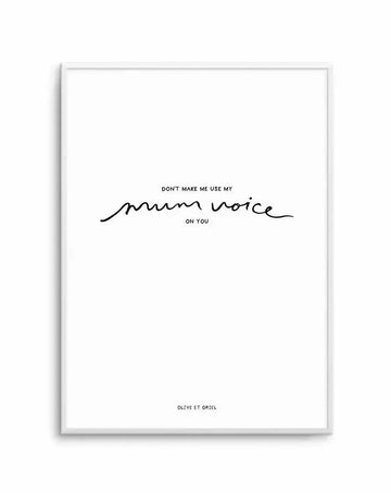 Framed art print with white border and silver-gray frame displaying hand-lettered text in black ink. The text reads "DON'T MAKE ME USE MY" in regular typeface, followed by "mum voice" in flowing, script-style handwriting, with "ON YOU" in regular typeface below. The design is minimalist on a white background. Credit line "OLIVE ET ORIEL" appears at the bottom in small text.