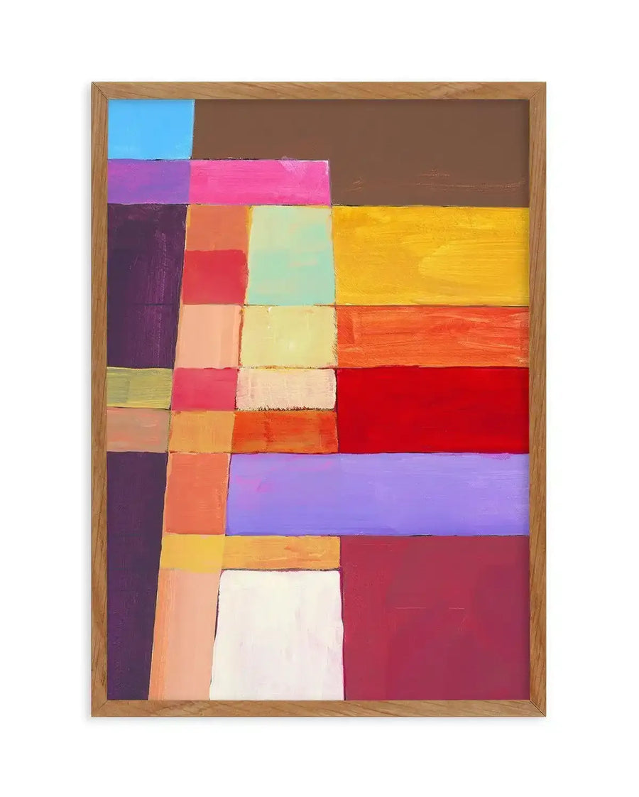 Abstract art print featuring a grid-like composition of various sized rectangular and square blocks of colour, reminiscent of a patchwork quilt. The colours include bright blue, deep brown, hot pink, purple, dark plum, peach, mint green, pale yellow, bright yellow, orange, red, lavender, and maroon, with visible brushstroke texture, displayed in a natural oak frame.