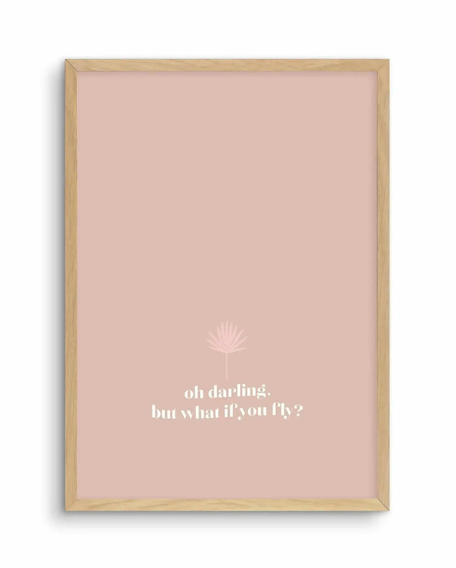 Framed art print with a natural wood frame displaying a dusty rose pink background. A delicate line-drawn dandelion illustration appears in the upper center portion. Below it, white text reads "oh darling, but what if you fly?" in a modern serif font. The composition is centered and minimalist, evoking an inspirational, contemplative mood.