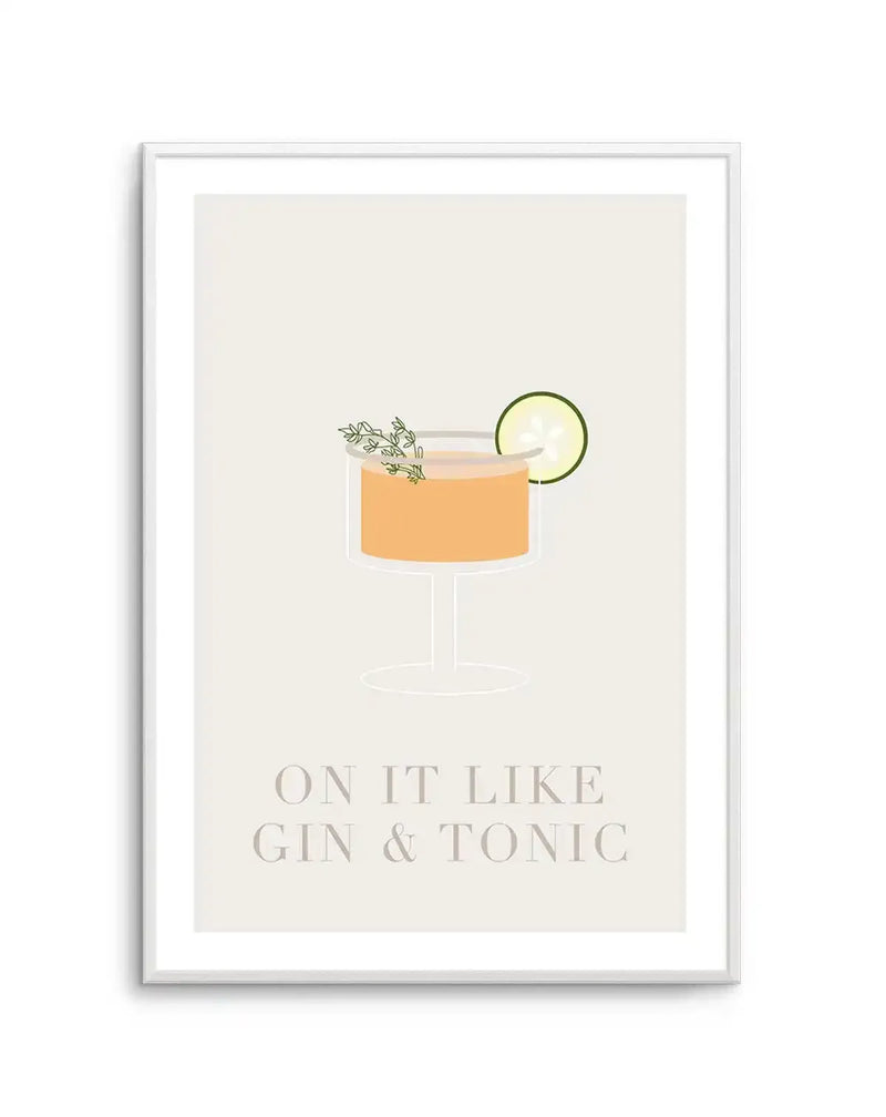 Framed art print featuring a minimalist illustration of a cocktail on a beige background. The drink is shown in a clear coupe glass filled with peachy-orange liquid, garnished with a lime wheel on the rim and fresh herb sprigs. Below the glass, text reads "ON IT LIKE GIN & TONIC" in large, light gray sans-serif lettering. The artwork is displayed in a silver-toned frame with a white border.