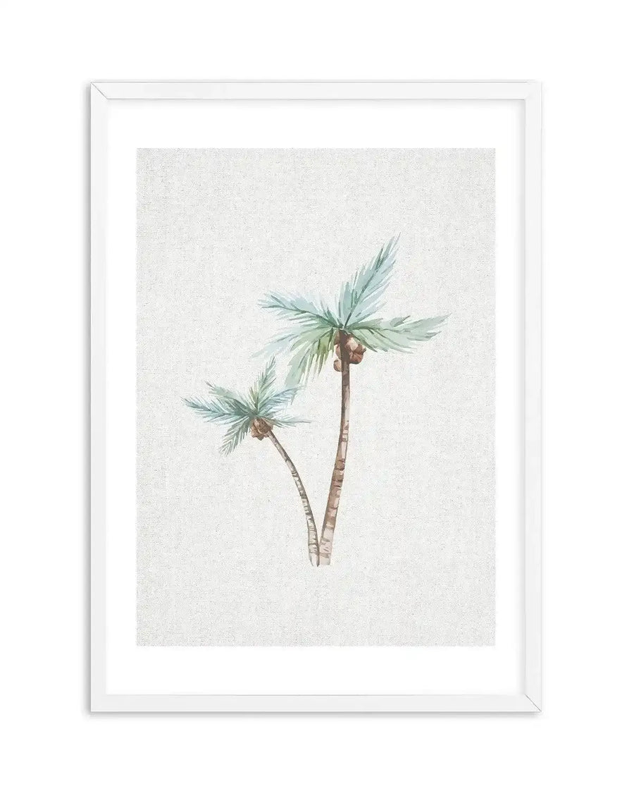 Watercolour art print featuring two palm trees with light blue-green fronds and brown coconuts, against a textured cream background, displayed in a white frame with white border. The taller palm is on the right, with a smaller, bent palm on the left.